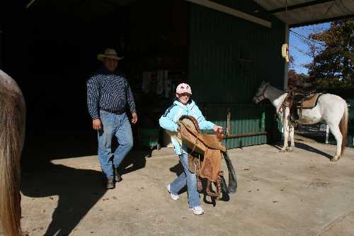 11 Toby teaches Sara to saddle.JPG